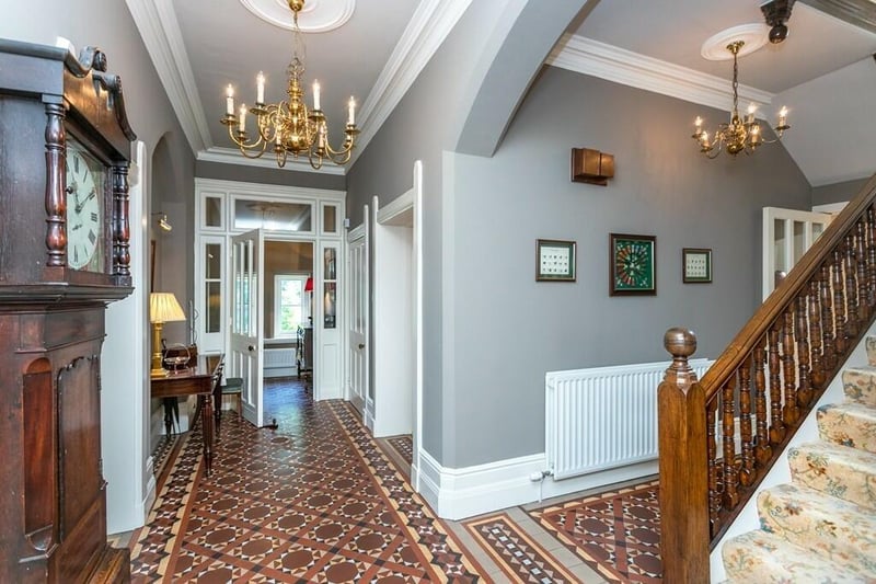 The entrance hall features an attractive decorative tiled floor.