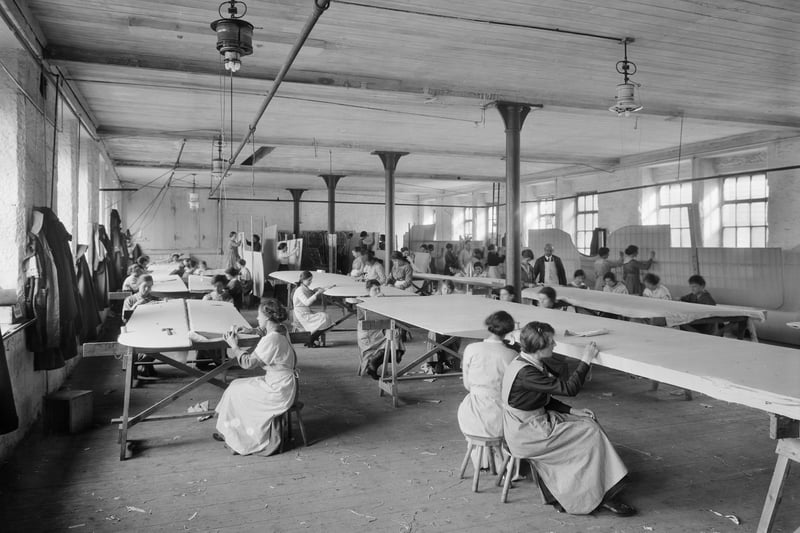 The production of biplane wings, showing female workers sewing wing fabric. Photographer: H Bedford Lemere.