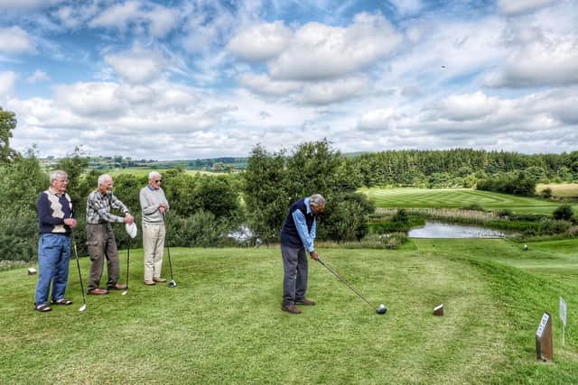 Phil Castle driving off at the 10th hole watched by (from left) Bob MacKeith, Pat Hanson and Geoff Hall.