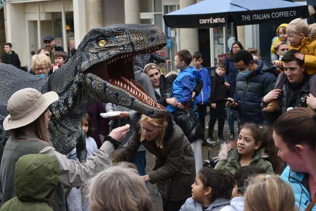 Dinosaurs walk the streets during a Dino Day in Lancaster.