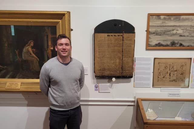 Richard Whittaker, museum officer, with the Williamson Factory Rule Board. Picture courtesy of Lancaster City Museums.