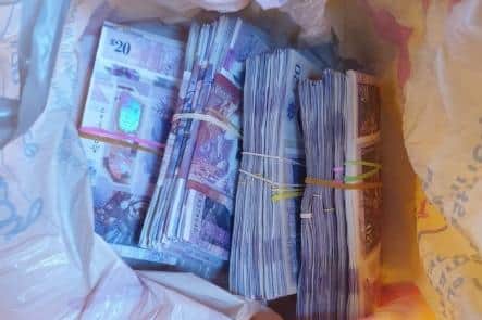 Police found £20,000 in a carrier bag in the man's van.