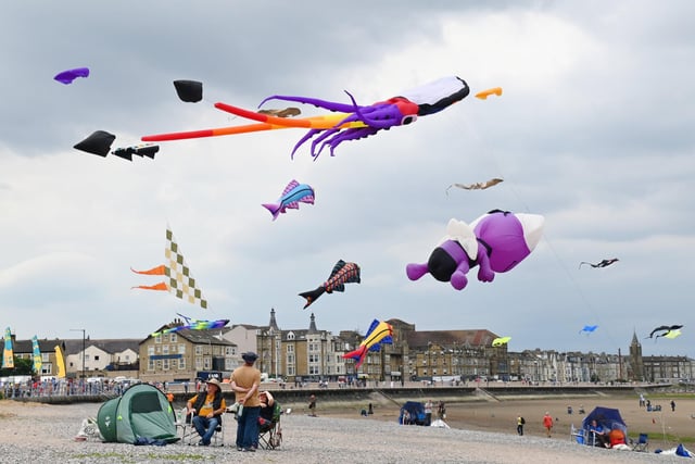 Onlookers enjoy looking at the kites being flown at the Catch the Wind Kite Festival in Morecambe. Picture by Michelle Adamson.