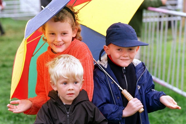 Young visitors to Garstang Show, James Parkinson, four, Richard and Caroline Moore (six and eight) shelter from the elements