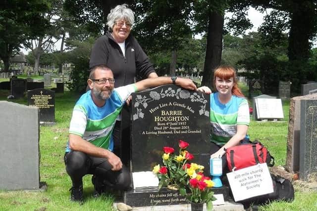 Mark Houghton pictured at his dad's grave at the end of his 450-mile walk from France. Also pictured are Mark's mum Margaret and his daughter Hannah.