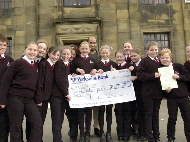 Pupils who raised £200 by baking cakes and biscuits for Barnardo's Big Bake presenting the cheque to Area Fundraiser for West Lancashire and Cumbria, Mehmood Laly (back).