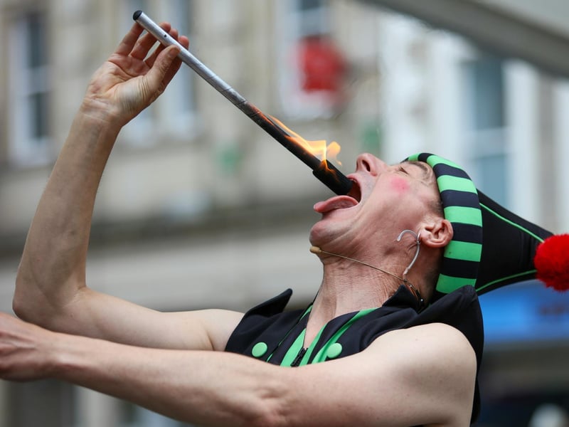 A performer eats fire at Lancaster Festa Italia.