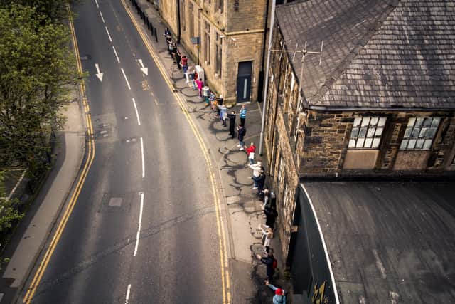 In April 2022, Lancaster Arts gathered members of the public together to create a snaking, overground impression of the buried Mill Race Stream that runs under Lancaster, as part of their project FLOW. Photo: Reel Things