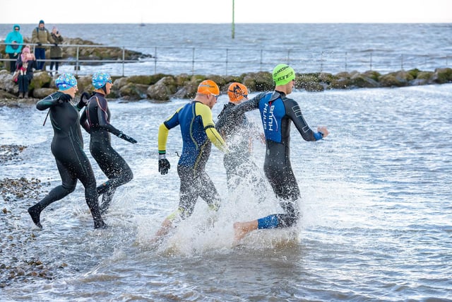 People in wetsuits brave the cold sea for the Boxing Day Dip. Picture by Jamie Buttershaw.