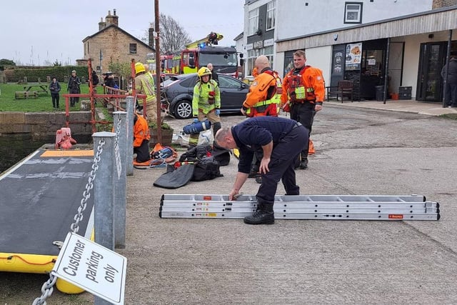 Firefighters rescue swan stranded in Lancaster village dock