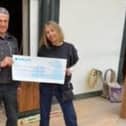 Janet Waddell presents £3,300 to Nick Smith from Queen's Market.