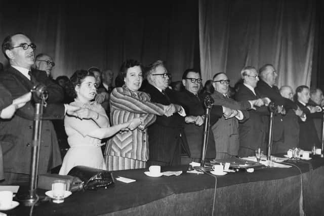 Delegates singing 'Auld Lang Syne' at the closing of the Labour Party Conference in Morecambe, UK, 3rd October 1952. From left to right, Peggy Herbison (1907 - 1996), Alice Bacon, Herbert Morrison, Morgan Phillips, Harry Earnshaw and Arthur Greenwood. (Photo by Keystone/Hulton Archive/Getty Images)