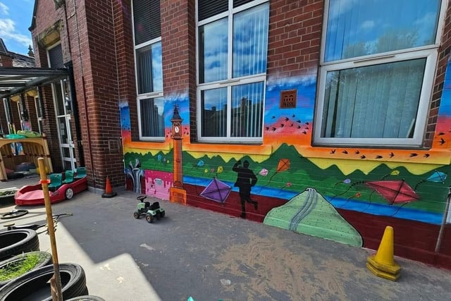 Eric Morecambe has been painted on one of the walls at Morecambe Bay C.P.  School as part of a mural.