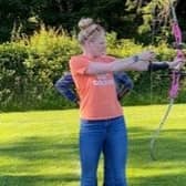 Polly Swann trying out archery during a visit home to Lancaster.
