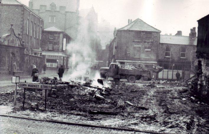 Smoke still rising from the market embers after the 1984 fire.