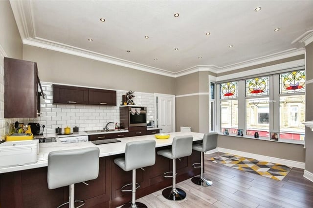The kitchen/diner with ample storage, breakfast bar and LED lighting.