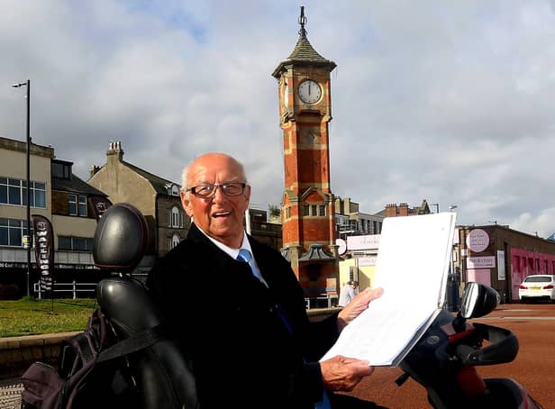 John Parkinson with his petition at the ready, pictured next to the famous clock tower in Morecambe. Photo by Tony North