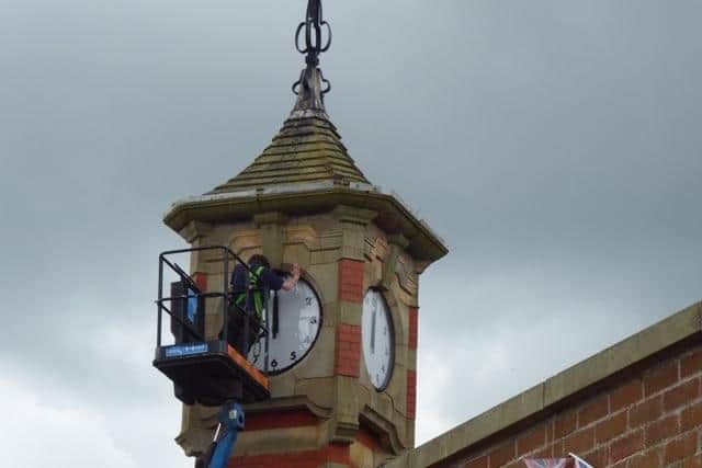 The repaired faces of the Morecambe Clock Tower are reinstalled but more works need to be done to get them ticking. Picture by Ruth Morris.