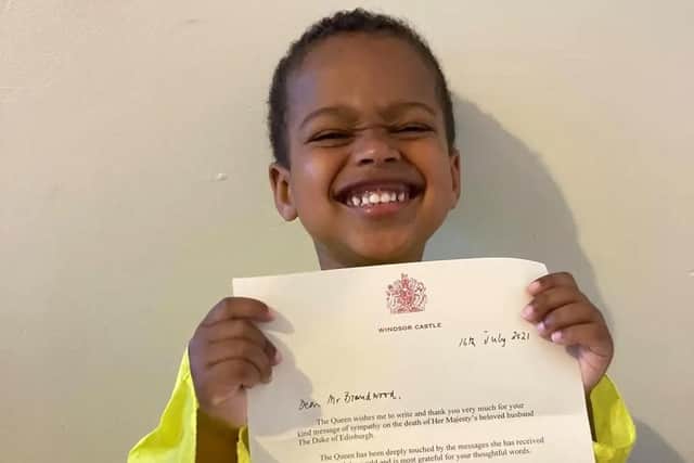A very proud Noah with his letter from the Queen. Picture by Josh Brandwood.