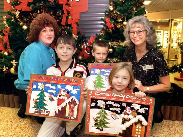 Asda's Christmas painting competition winners from left Scott Berry, 1st; Steohen Smith, 3rd and Hannah Lancaster, 2nd. Presenting the prizes are from left Customer Service Managers Helania Hopkinson and Carole Keen.