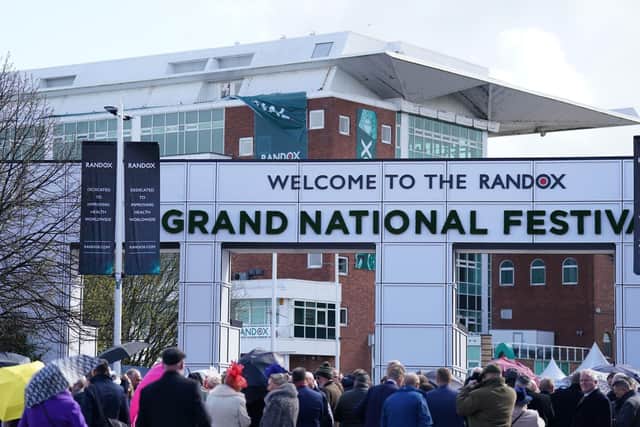 Racegoers queue at Aintree Racecourse, ahead of the opening day of the Randox Grand National Festival