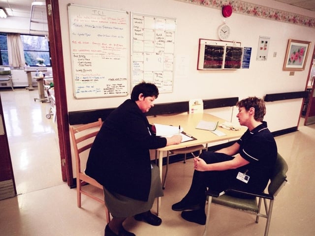 Ward sister, Anne Craig talks to a colleague on ward 23 at the RLI in 2000. Photo by DJ Clark.