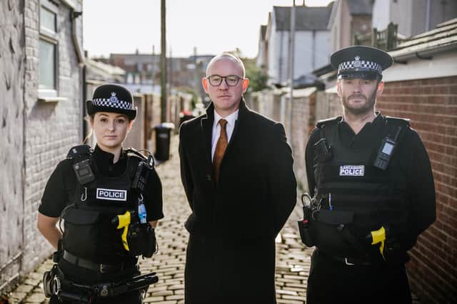 Andrew Snowden, Police and Crime Commissioner for Lancashire (centre) with police officers.