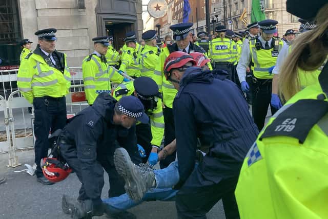 Police remove demonstrators during an Extinction Rebellion protest at Marble Arch in central London on Saturday April 16, 2022. Rebecca Speare-Cole/PA Wire