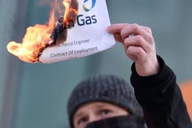 A striking British Gas engineer sets fire to a contract in the fire and re-hire dispute at British Gas last year