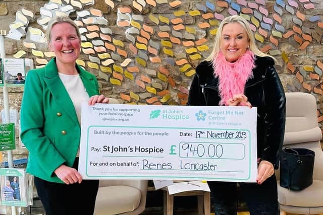 Tiffany Moore of Renes presents Catherine Butterworth, director of income generation at St John's Hospice, with a cheque for £940.