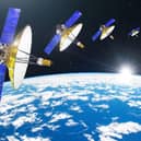 Group of satellites with dish antennas in orbit around the Earth, for communication and monitoring systems. Elements of this image furnished by NASA