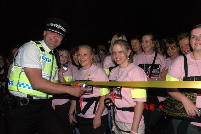 Police Divisional commander Tim Jacques cuts the ribbon to start the 2009 Moonlight Walk.