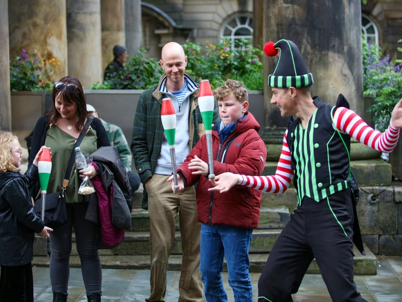 Getting to grips with juggling with one of the performers at Festa Italia.