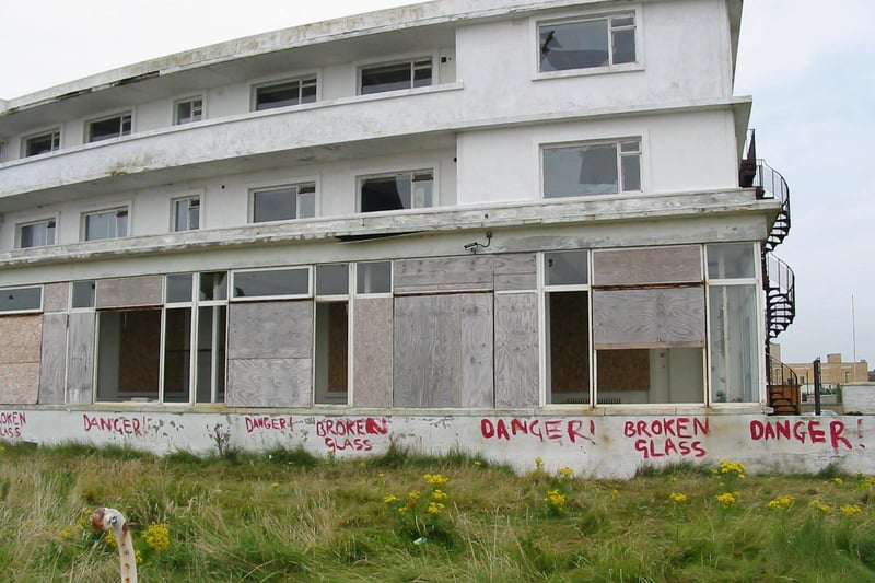 Smashed windows at Morecambe's Midland Hotel during the years it was closed.