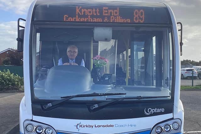 Jeff Wright with his bunch of flowers to brighten his passengers' day. Picture: Ken Bennett.