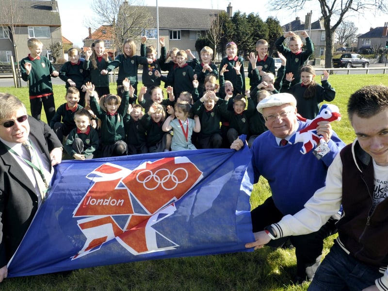 Children from Lancaster Road School with headteacher Paul Gabriel, Coun Ron Sands, cabinet member for tourism and culture, and Olympic torch bearer Matthew Prior celebrate the announcement of the torch route.