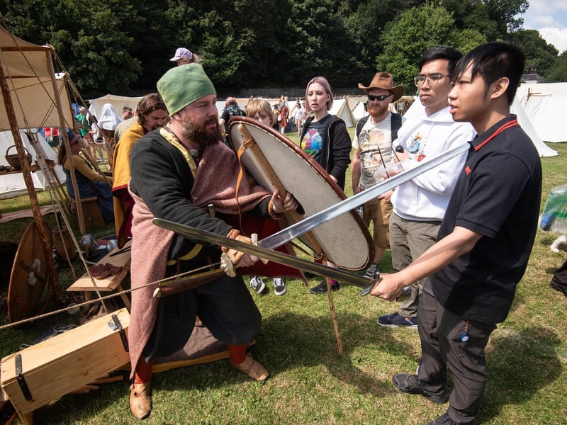 Heysham Viking Festival 2026 - discussing and demonstrating swords with festivalgoers.