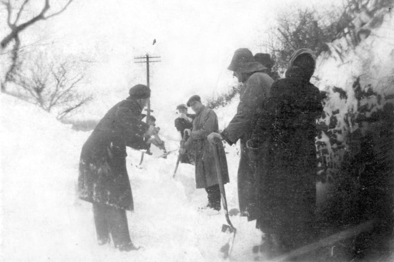 Road workers clearing the snow near the Cat and Rat railway bridge near Hornby in January 1947.