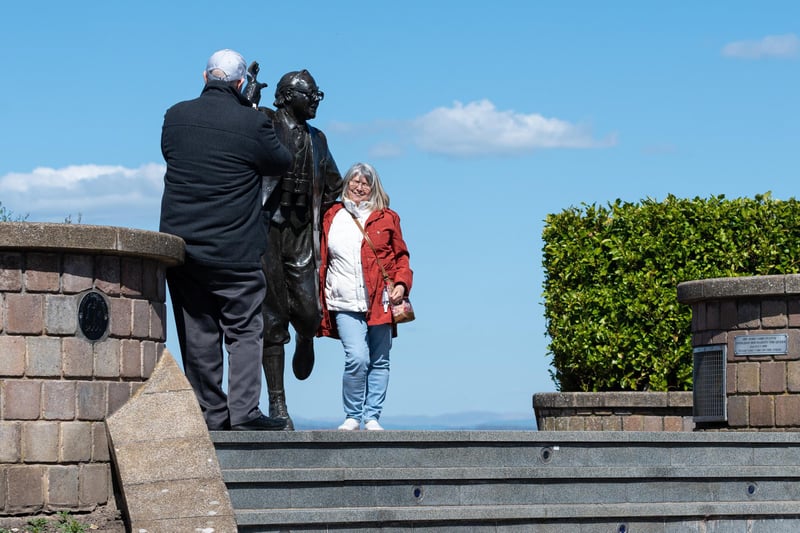 Visitors to Morecambe take advantage of the good weather to get a photo with Eric.