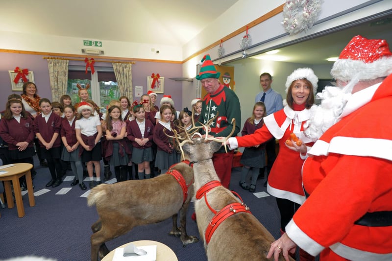 Father Christmas and his helpers with his reindeer Blizzard & Bell during a visit to St John's Hospice with children from Slyne-with-Hest Primary School who sang carols.