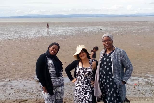 Smiles at the seaside from refugees who came to Morecambe on a train trip.