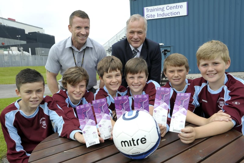 Heysham 2 Power Station director Alan Oulton (right) and Andy Lockley of Heysham 2 with Westgate Wanderers under 13s team members and their tickets to see the final stages of Olympic football at Old Trafford in 2012. EDF Energy was an official partner of the London 2012 Olympic and Paralympic Games and provided 70 tickets for Trumacar, St Peter's, Mossgate, St Patrick's and Westgate Primary Schools, and Westgate Wanderers.