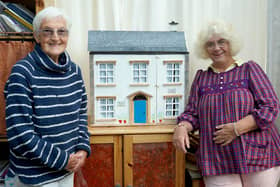 Freda Simpson (left) and Val Hall with the dolls' house which has been donated to the Forget Me Not Centre at St John's Hospice, Lancaster.