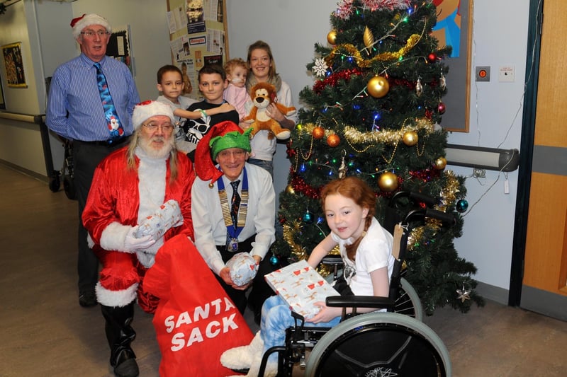 Lancaster and Morecambe Lions Club members, president Mike Kaliszczak, Dave Milnes, Neil and Rosemary Ryder, delivered presents with the help of Father Christmas to youngsters in the Children's Ward at the Royal Lancaster Infirmary. Pictured with the Lions are Elinor Taylor, Tom and Jayden Johnson, Eloise Miles with her mum Clare Beales.