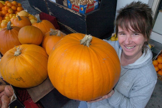 Trisha Birkby from The Greengrocers on Common Garden Street, Lancaster, with some of the large pumpkins ready for Halloween.