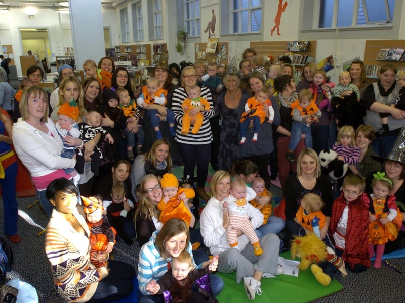 Parents and children at a Baby Bounce and Rhyme Halloween event held at Lancaster Library.