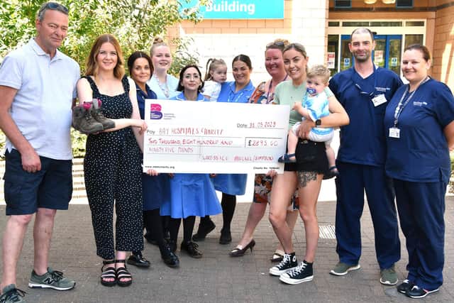 Amy and Hannah present their funds to Bay Hospitals Charity and the teams at Royal Lancaster Infirmary.
