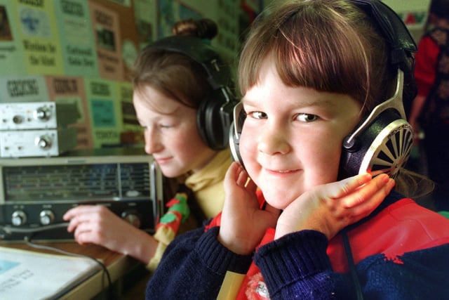Six-year-old Holly Austin (front) of the 4th Morecambe Rainbows and 10-year-old Zoe Green of the 4th Morecambe Brownies listen to a short wave radio. The girls had the chance to explore the world of radio on when they were visited by the Bay Amateur Radio Group