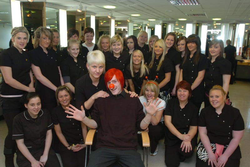 Liam Drinkwater, level 2 NVQ Hairdressing student at Lancaster and Morecambe College, with his hair dyed red and then cut by stylist Lisa Care, raising £150 for Comic Relief. He is pictured with fellow Level 2 NVQ Hairdressing students.