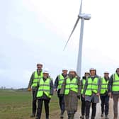 The OnPath energy team near one of the wind turbines.